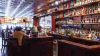 Interior shot of Bluegrass Tavern featuring a very well stocked bar full of bourbon.