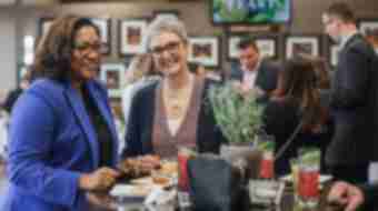 Two women enjoying great food at the event F.E.A.S.T.