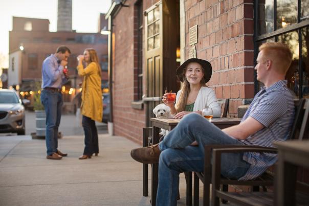 Friends enjoying drinks on the patio at Elkhorn Tavern.
